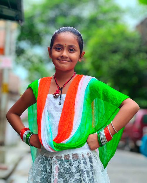 Free A young girl in traditional attire celebrating Indian Independence Day on a street in Kolkata. Stock Photo