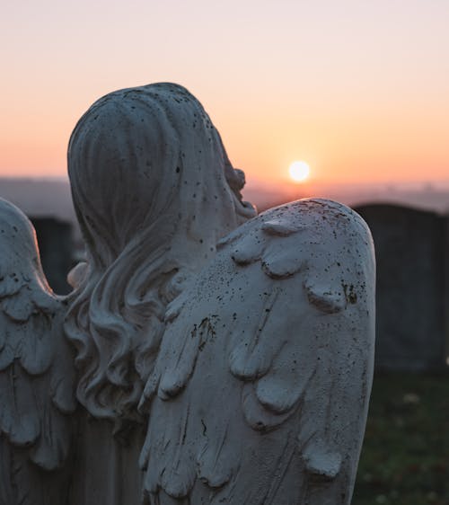 Angelic Statue and Sunset Scenery