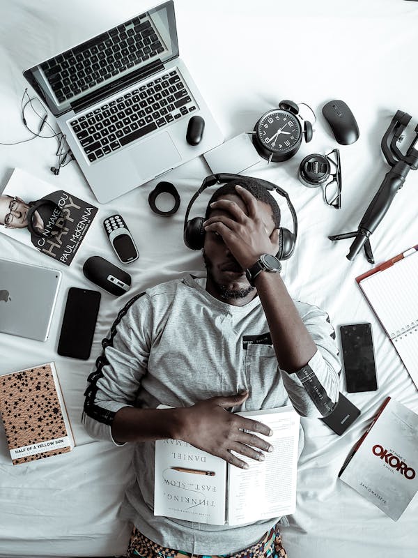 wholesale electronics is a tough market! image of a man with a lot of electronics around him.