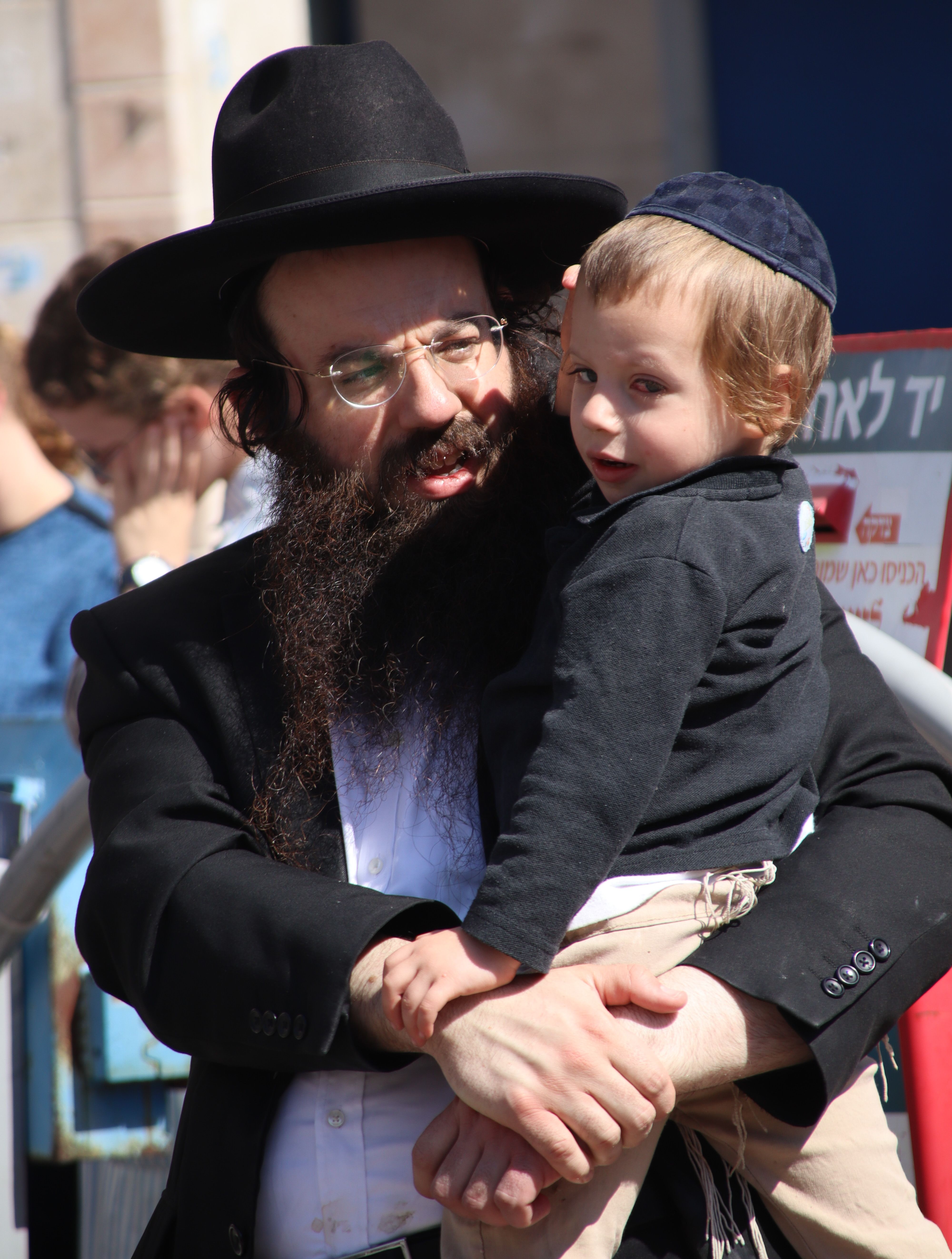 A Jewish man holds his child during Passover celebration in Bnei Brak, Israel.