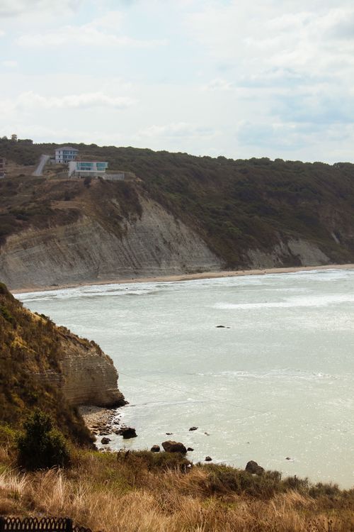 Free Breathtaking view of rugged coastal cliffs overlooking a serene azure ocean. Stock Photo