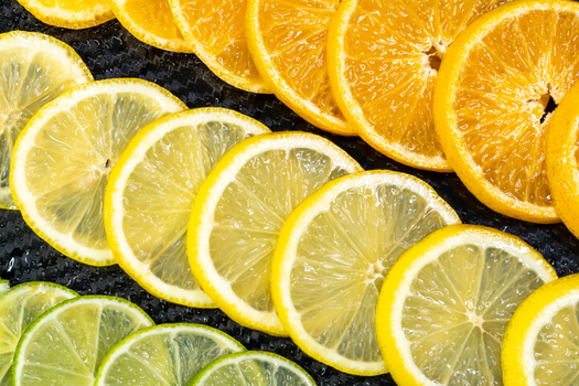 Colorful arrangement of citrus slices featuring oranges, lemons, and limes for a refreshing and healthy vibe.