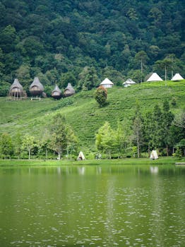 Beautiful view of lakeside dwellings surrounded by lush greenery in West Java, Indonesia.
