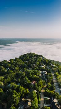 Stunning aerial shot of Chattanooga, Tennessee showcasing lush greenery and cloud-covered hills.