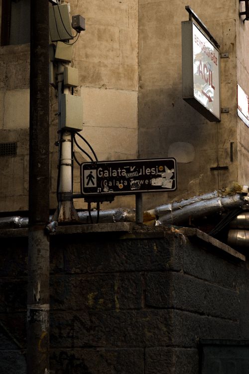 Free Street sign in Istanbul's Galata neighborhood with urban architectural backdrop. Stock Photo