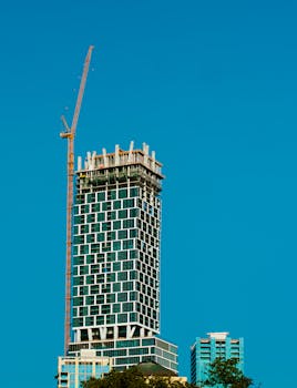 Skyline view of a skyscraper under construction in Austin, Texas with a towering crane.