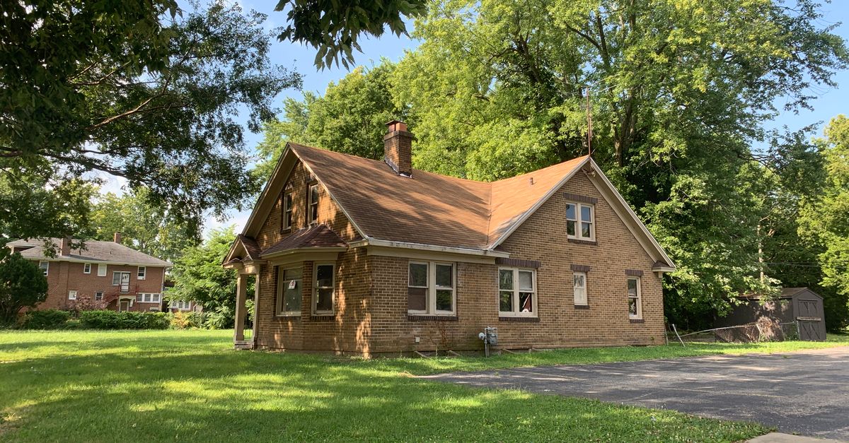 Charming brick house surrounded by trees in a quiet Decatur neighborhood. Perfect for real estate and lifestyle imagery.