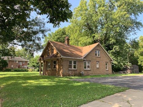 Charming brick house surrounded by trees in a quiet Decatur neighborhood. Perfect for real estate and lifestyle imagery.
