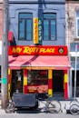 Vibrant storefront of 'My Roti Place' with bold signage, bicycle parked outside.