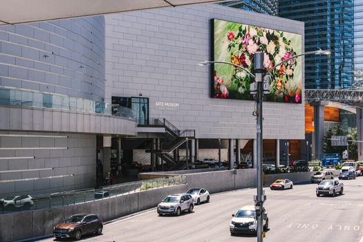 Street view of Arte Museum in Las Vegas showcasing vibrant digital art on a sunny day.