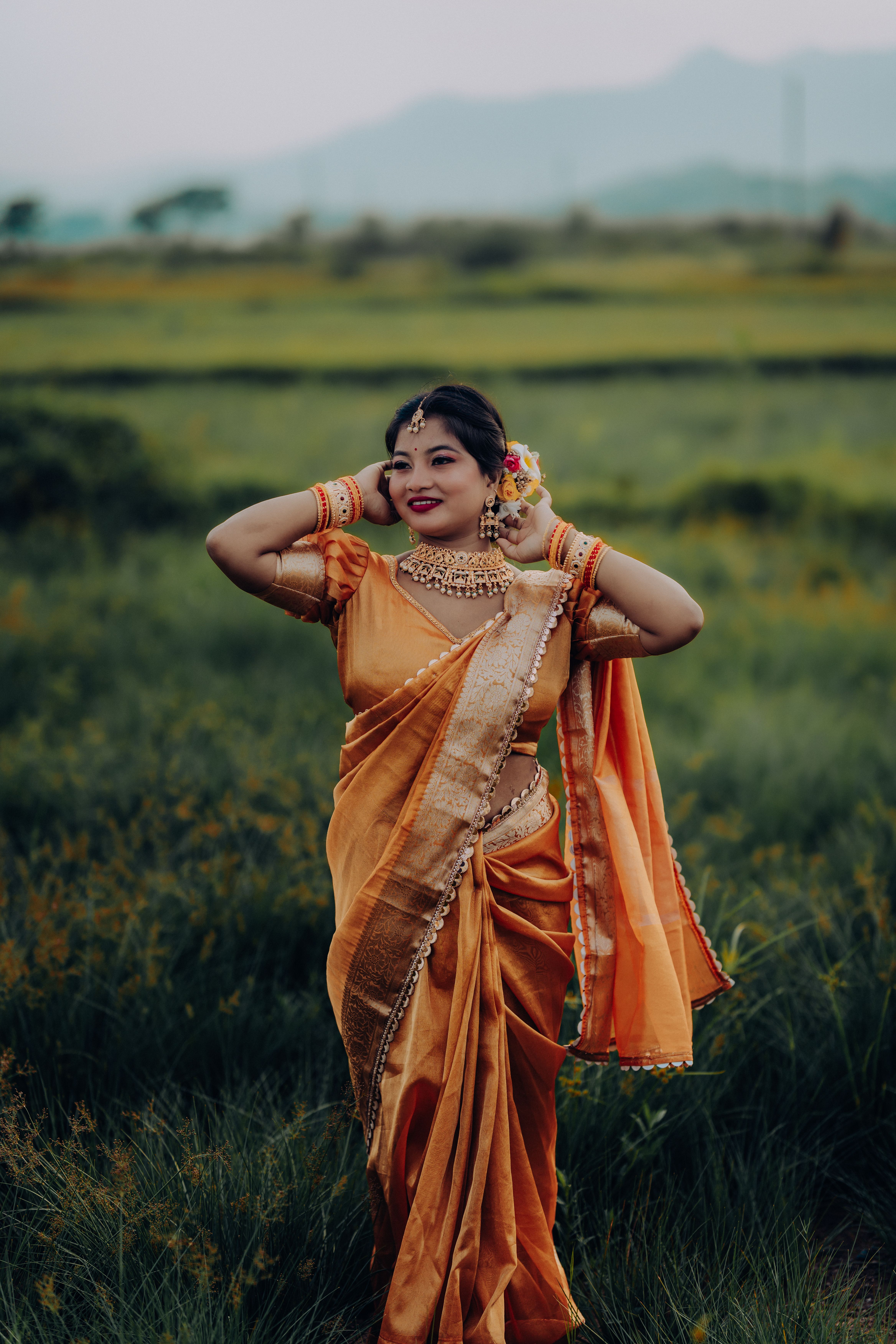 Elegant Woman in Traditional Golden Saree Outdoors · Free Stock Photo