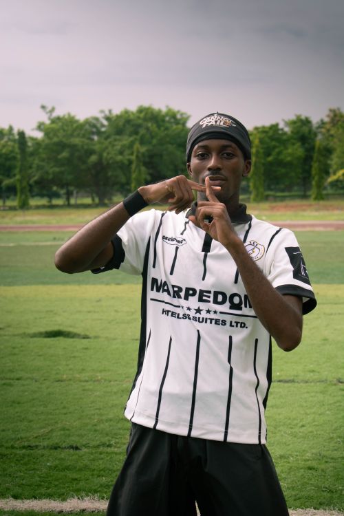 Free Teen soccer player on a field making a gesture towards the camera. Stock Photo