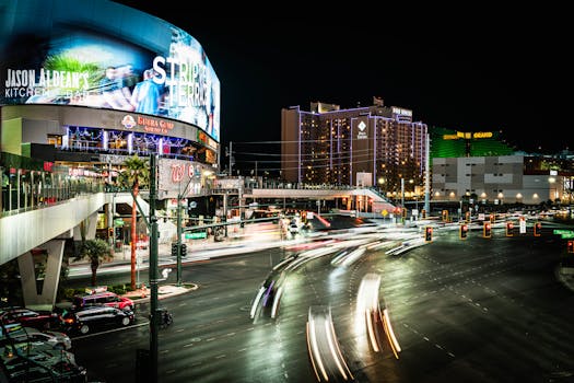 Dynamic night scene on the Las Vegas Strip featuring vibrant lights and busy intersections.