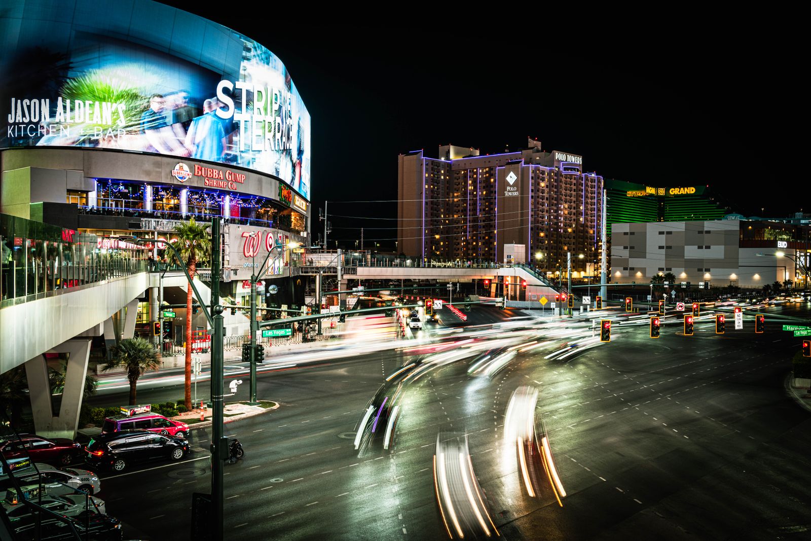Neon-lit Las Vegas Strip glowing at night with car light trails, the backdrop for a bachelor party weekend