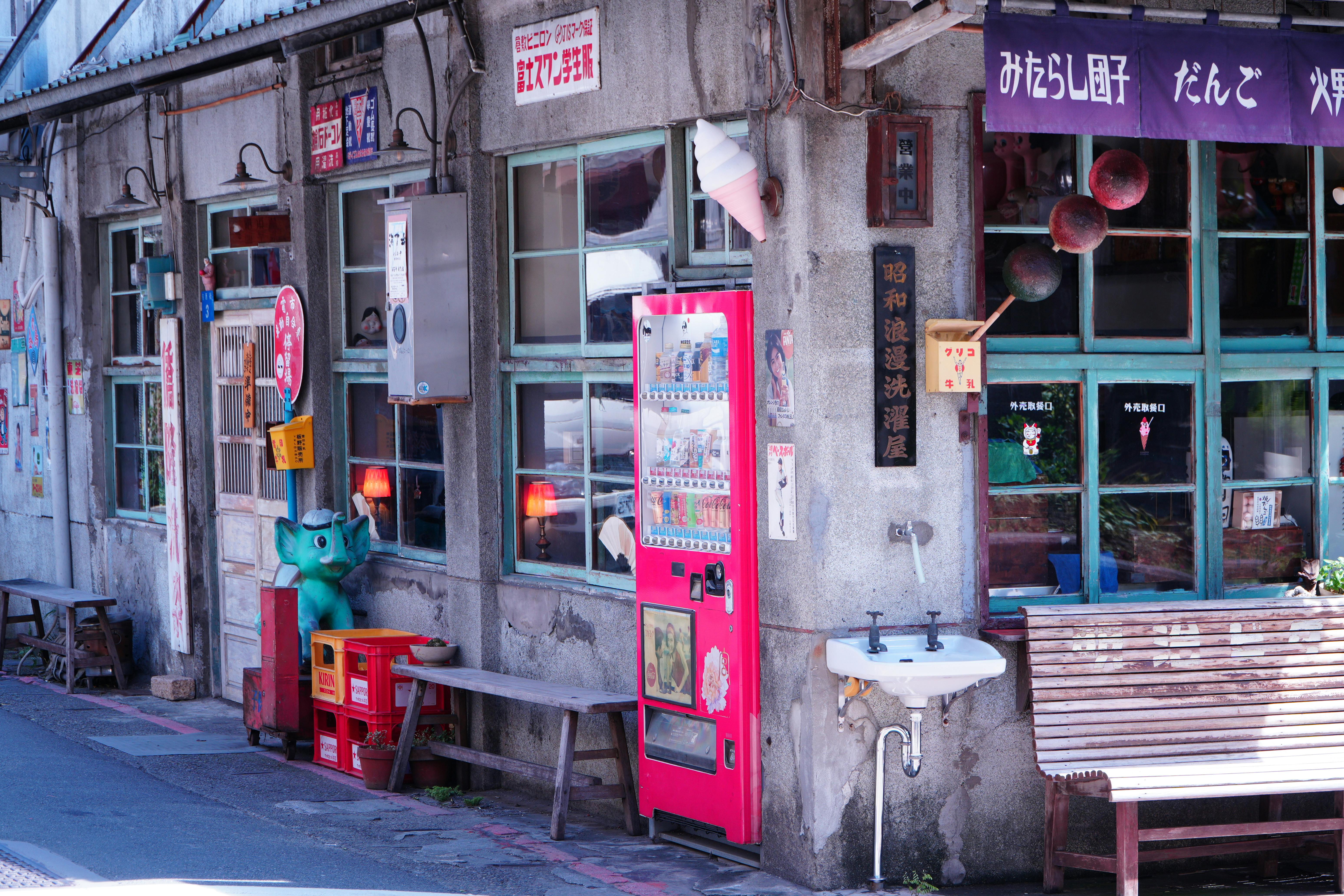 Vibrant street view in Taipei's historic Dihua Street with vintage elements and vending machines.