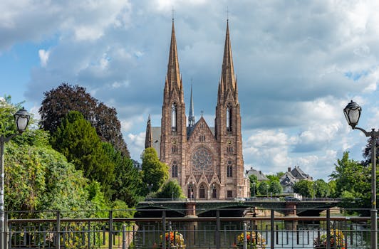 St. Paul's Church in Strasbourg, France surrounded by lush greenery under a vibrant sky.