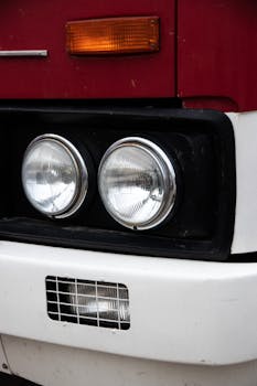 Detailed view of a retro truck's headlights and grille, showcasing vintage design.