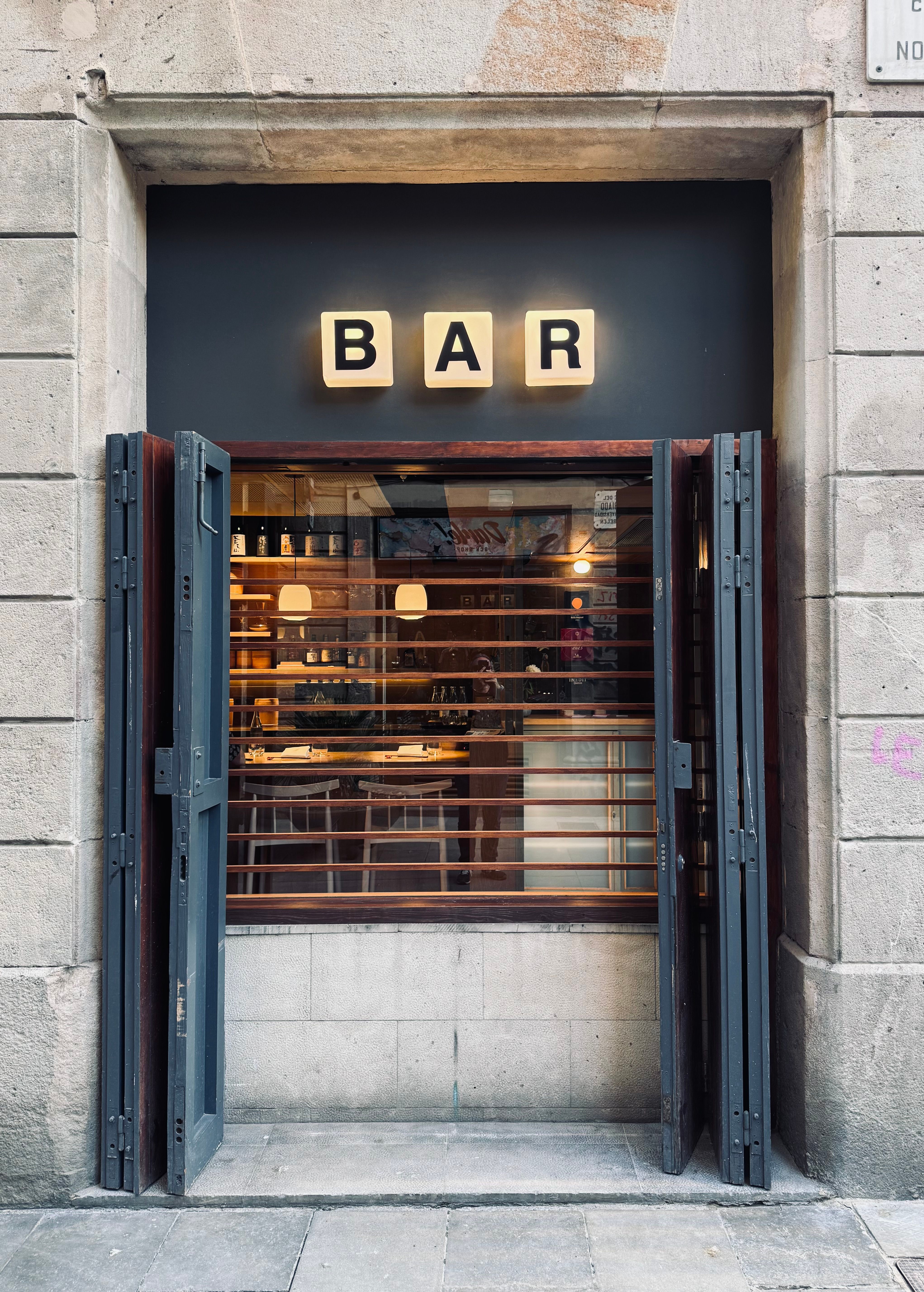 A cozy and inviting bar entrance in the heart of Barcelona's historic Gothic Quarter.