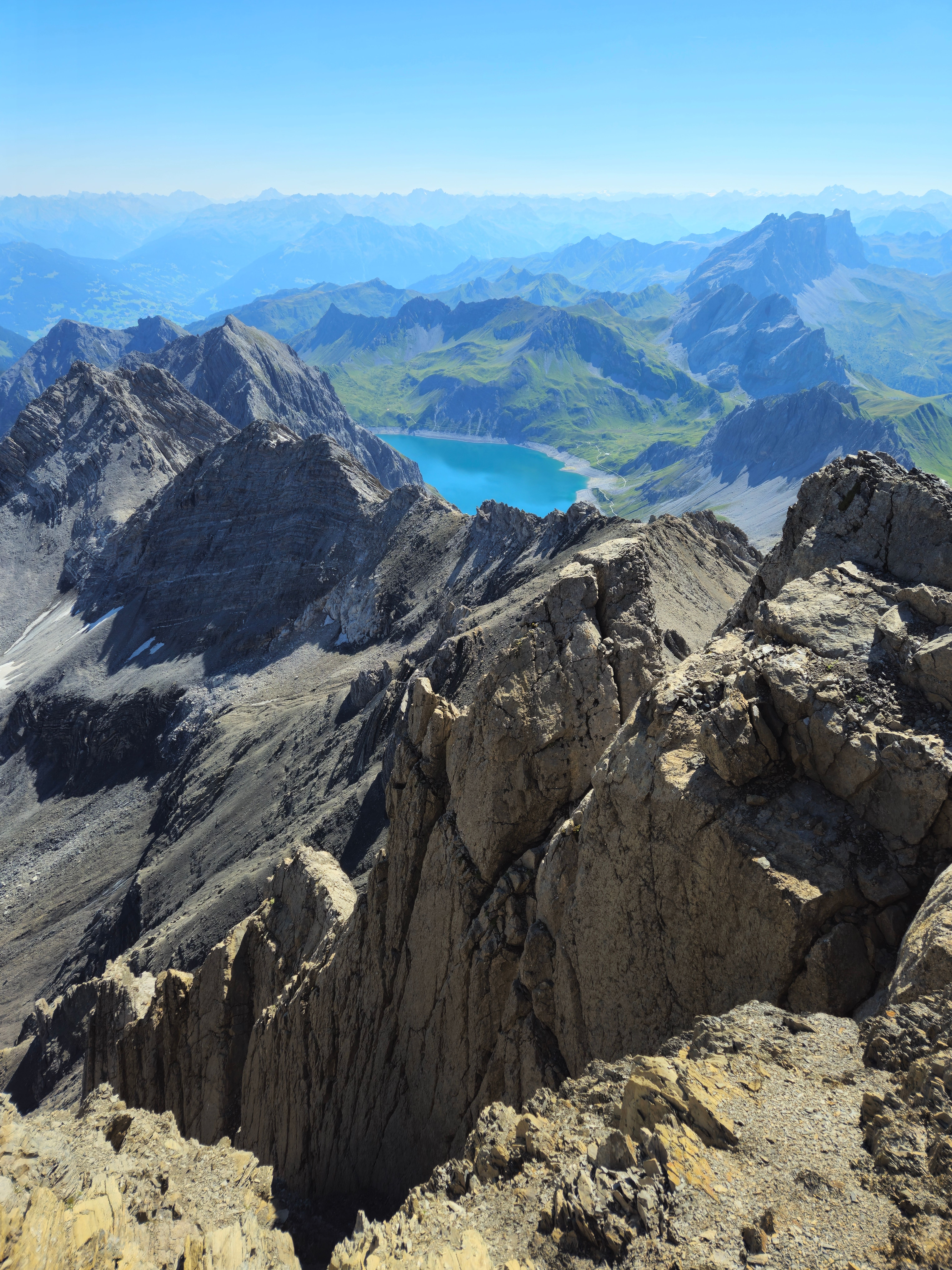 Breathtaking view of alpine mountains and a crystal-clear lake in Vorarlberg, Austria.