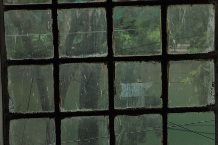 Dirty window with streaks and grime before cleaning
