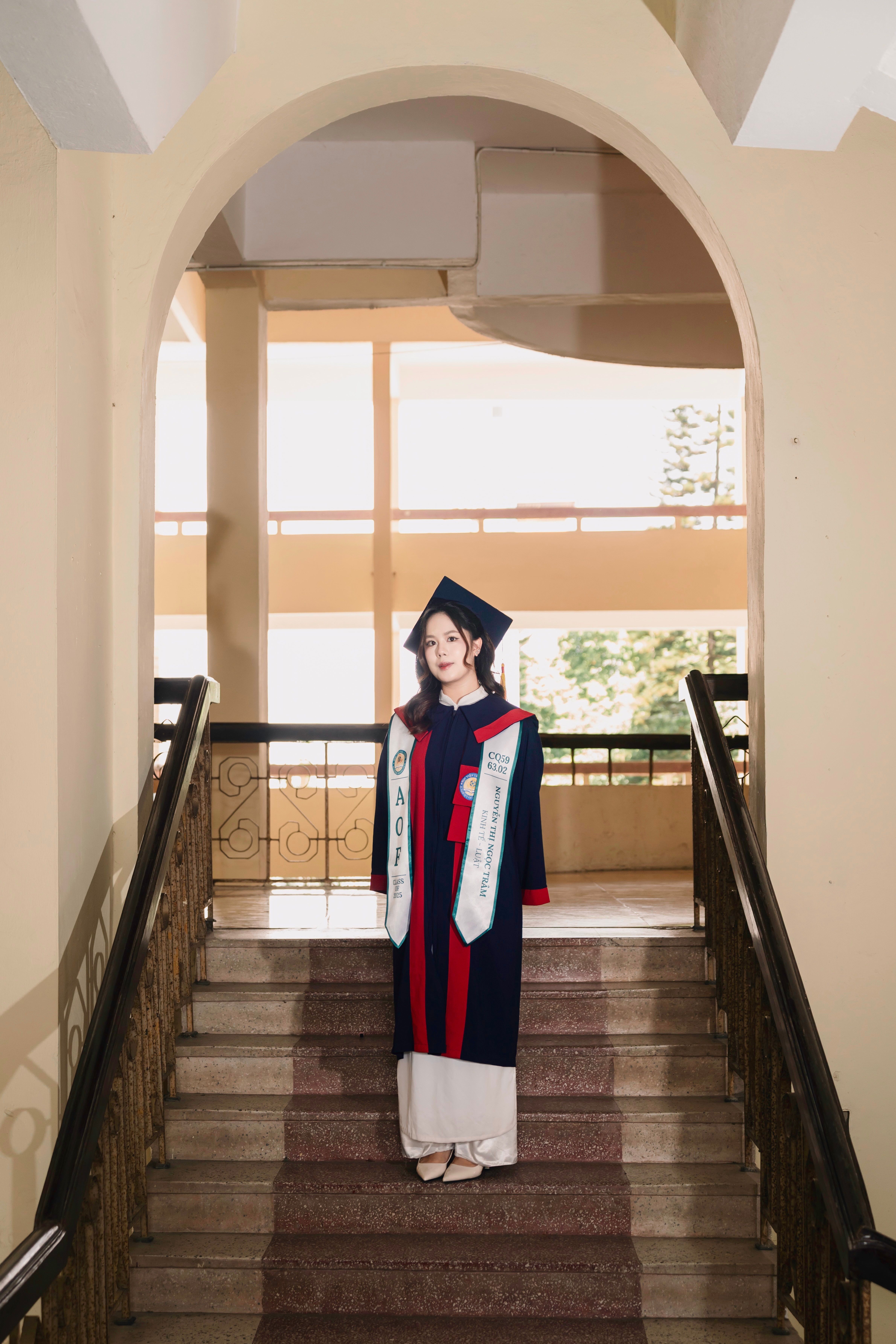 Elegant Graduation Portrait on Staircase · Free Stock Photo