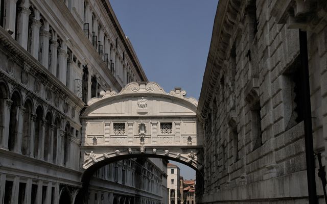 Photo: Christina & Peter on Pexels The iconic Bridge of Sighs connecting two historic Venetian buildings under the blue sky.