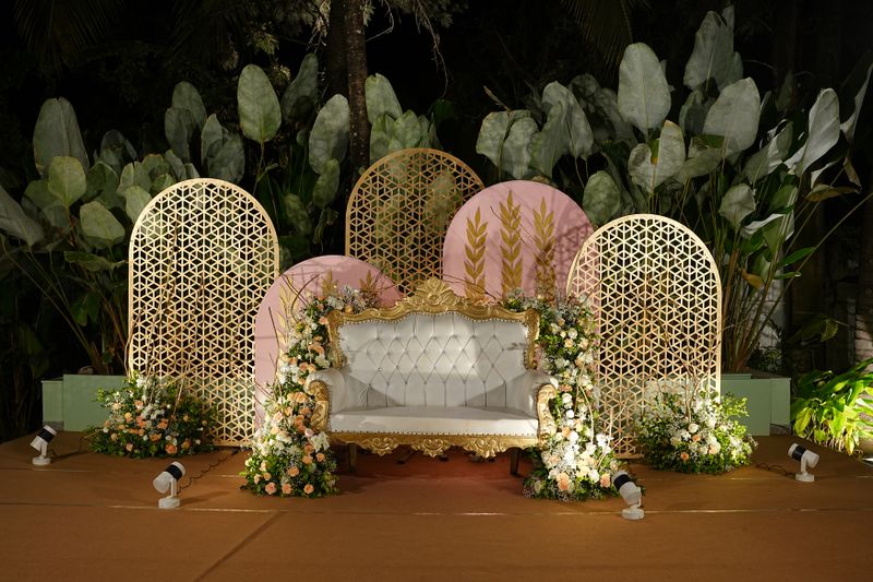Elegant night wedding stage with chandeliers and white floral arrangements