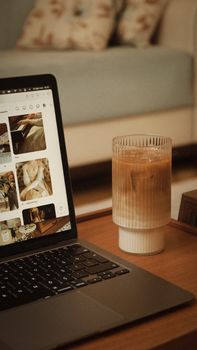 A cozy indoor scene featuring an iced coffee beside a laptop, perfect for remote work.