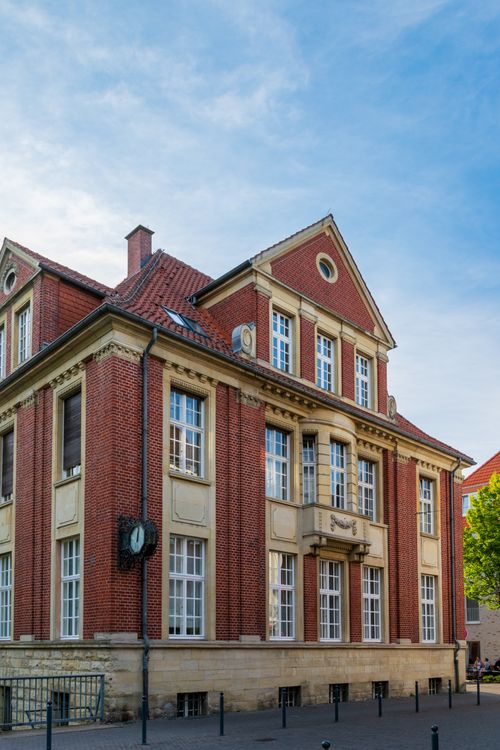 Free Charming historic red brick building showcasing classic architectural style against a blue sky. Stock Photo