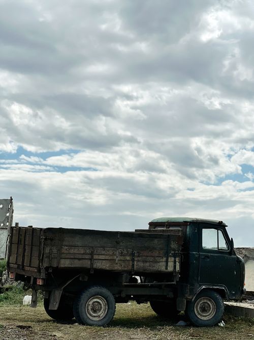 Free Vintage truck parked under a cloudy sky in rural Tūghyl, Kazakhstan. Stock Photo