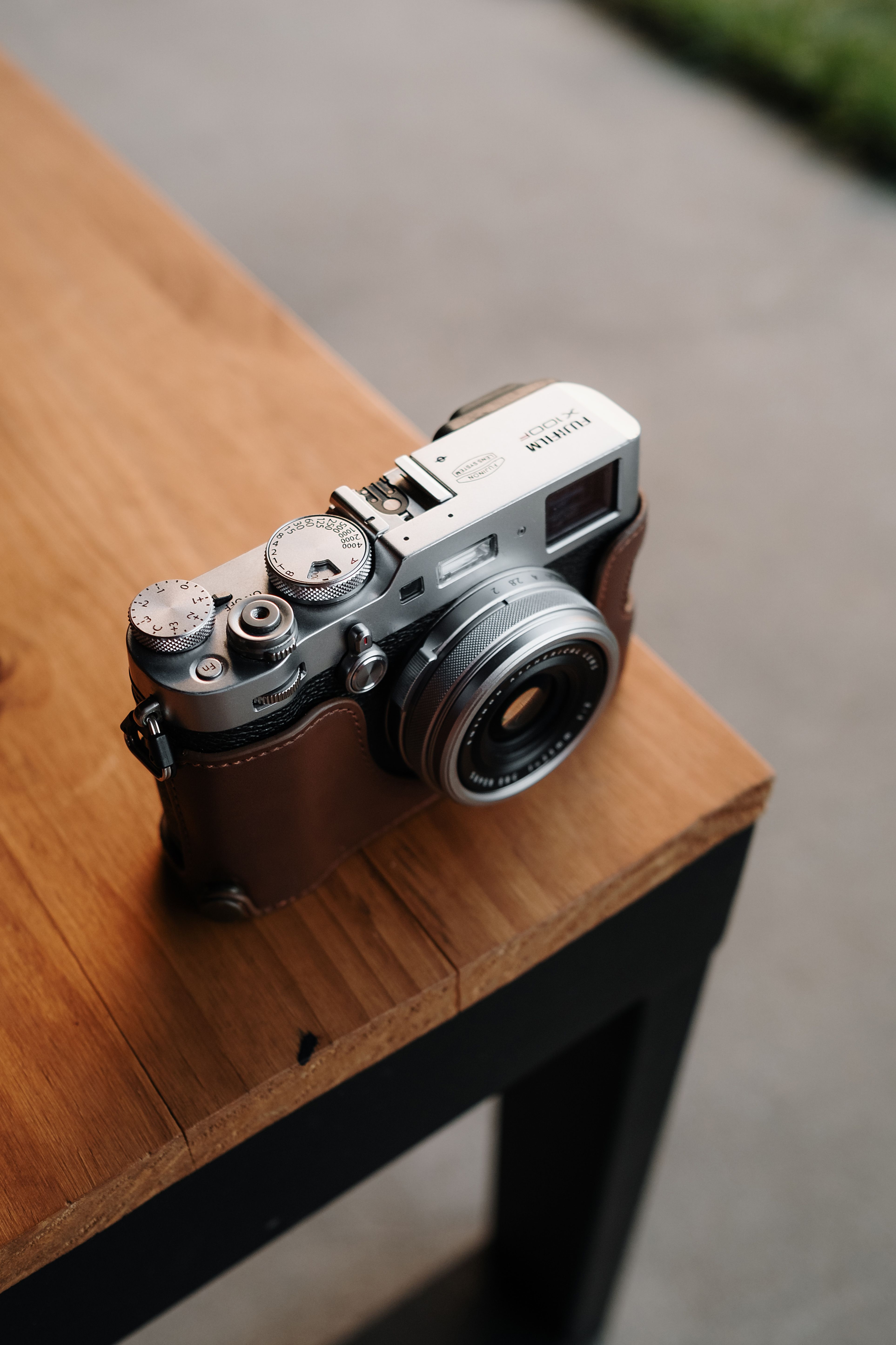 Close-up of a retro camera on a wooden table providing a nostalgic feel.