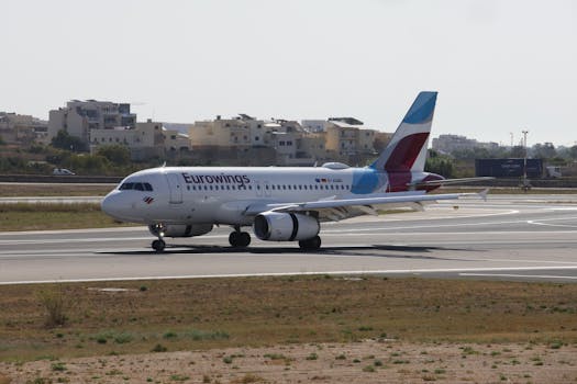 Eurowings Airbus A319 preparing for takeoff on a sunny airport day.
