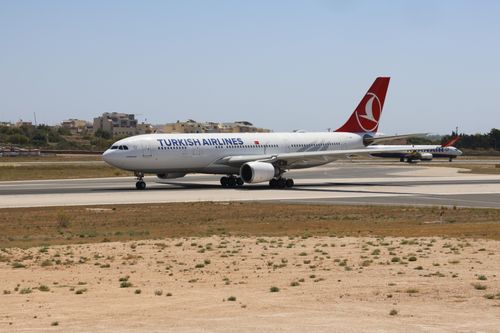 Free Turkish Airlines aircraft preparing for takeoff on a sunny day airport. Stock Photo