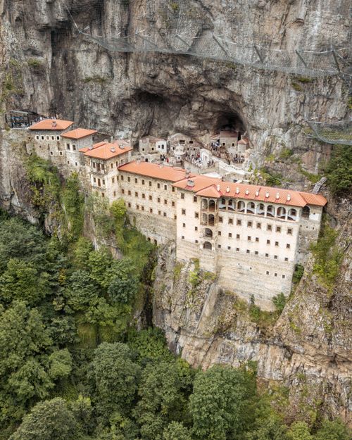 Free Aerial view of the historic Sumela Monastery built into a dramatic cliff face. Stock Photo