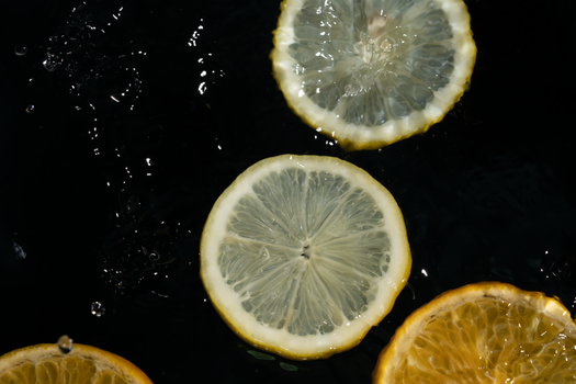 Captivating image of vibrant citrus slices floating in water, capturing freshness and vitality.