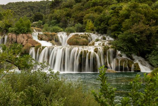 Stunning waterfalls surround lush greenery in Krka National Park, perfect for nature lovers.
