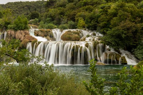 Free Stunning waterfalls surround lush greenery in Krka National Park, perfect for nature lovers. Stock Photo