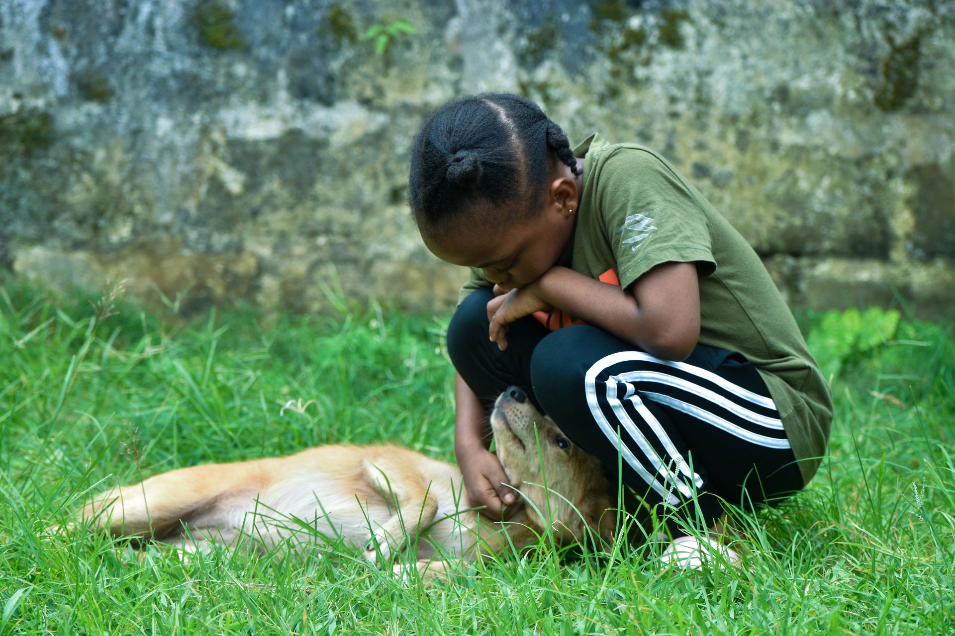 Liberian girl playing with her dog