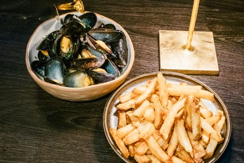 Free A tantalizing plate of mussels and fries, fine dining in Calgary, Alberta. Stock Photo
