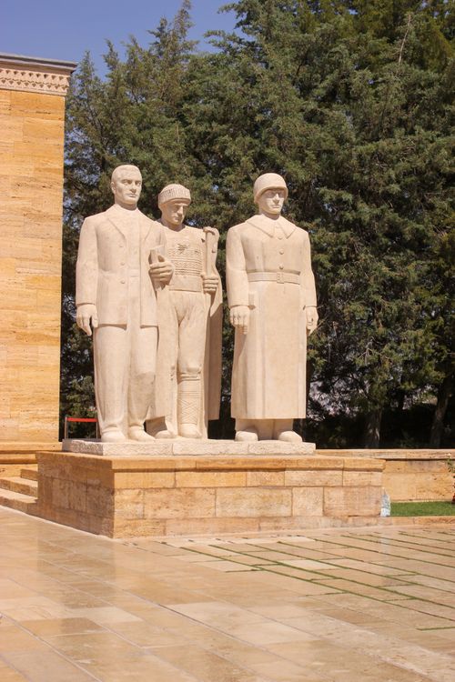 Free Three stone statues of soldiers representing historical figures in an outdoor setting. Stock Photo