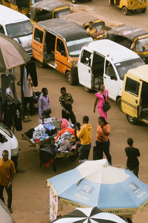 Free A bustling street market scene with people and vehicles in Enugu, Nigeria. Stock Photo