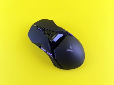 Stylish black gaming mouse with LED lights on vibrant yellow background.