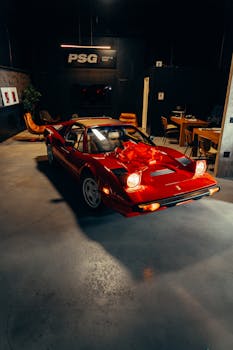 A classic red sports car featured in a stylish modern garage setting.