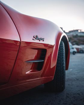 Close-up side view of a red Stingray car during sunset, showcasing its sleek design in İzmir, Türkiye.