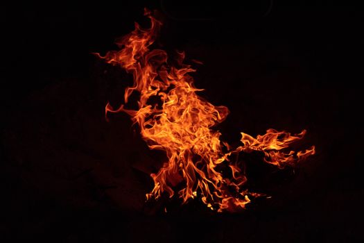 A mesmerizing display of bright, vivid flames dancing in the darkness.