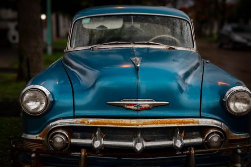 Free Front view of a classic blue car with rust details, parked in Mar del Plata, Argentina. Stock Photo