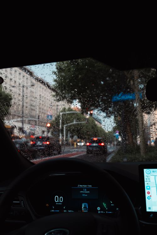Free View of city street through a car windshield on a rainy day. Stock Photo