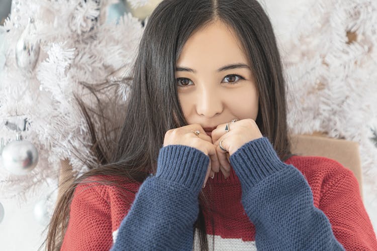 Crop Pleasant Asian Woman Against White Christmas Tree