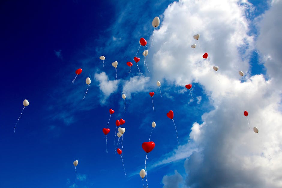 White and Red Plastic Heart Balloon on Sky during Daytime