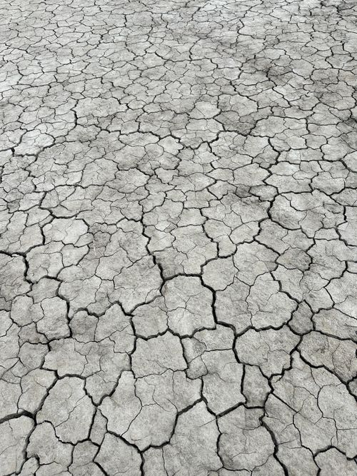 Free Overhead view of cracked dry earth, symbolizing drought and climate change. Stock Photo
